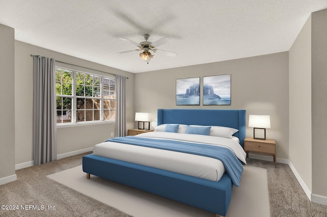 bedroom with ceiling fan, a textured ceiling, and carpet floors