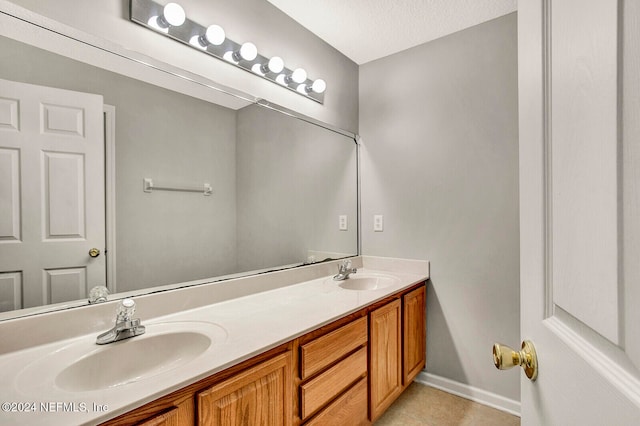 bathroom with vanity, tile patterned flooring, and a textured ceiling