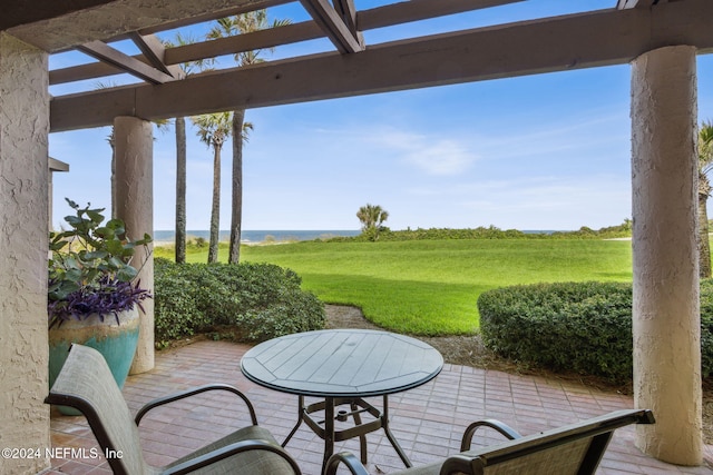 view of patio with a rural view, a water view, and a pergola