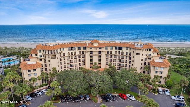 birds eye view of property featuring a water view and a view of the beach