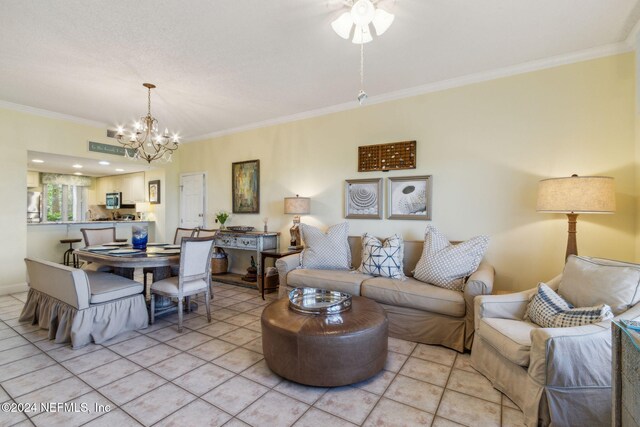 living room with ceiling fan with notable chandelier, light tile patterned floors, and crown molding