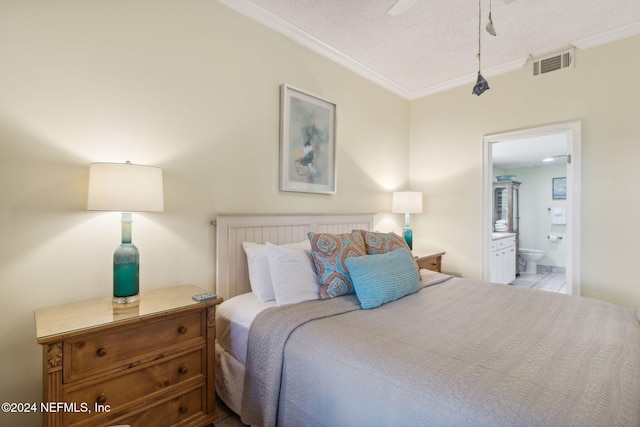 bedroom featuring light tile patterned flooring, ensuite bath, ornamental molding, ceiling fan, and a textured ceiling