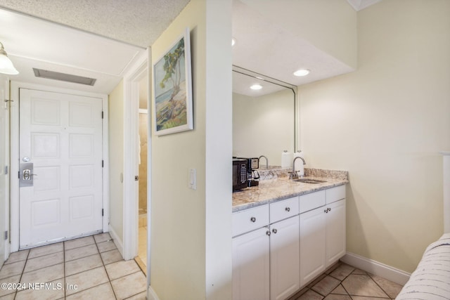 bathroom featuring vanity and tile patterned flooring