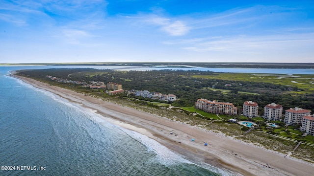 drone / aerial view featuring a water view and a beach view