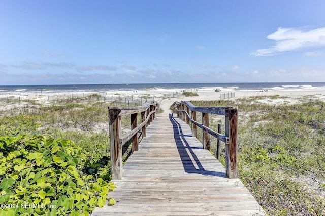 view of community with a beach view and a water view