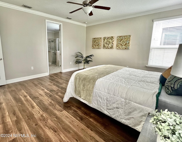 bedroom with ensuite bath, ceiling fan, dark hardwood / wood-style floors, crown molding, and a textured ceiling