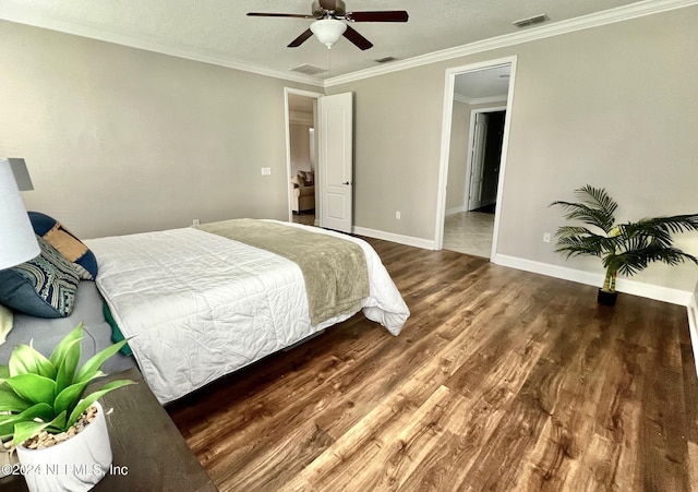 bedroom with ceiling fan, dark wood-type flooring, and ornamental molding