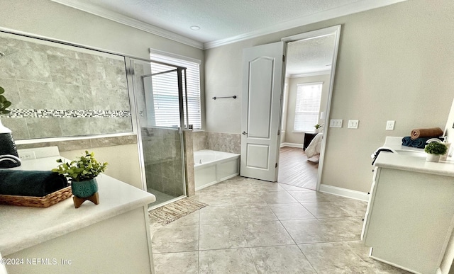 bathroom with tile patterned floors, a wealth of natural light, a textured ceiling, and ornamental molding