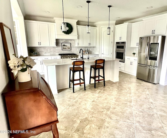 kitchen with white cabinets, a kitchen island with sink, hanging light fixtures, and appliances with stainless steel finishes