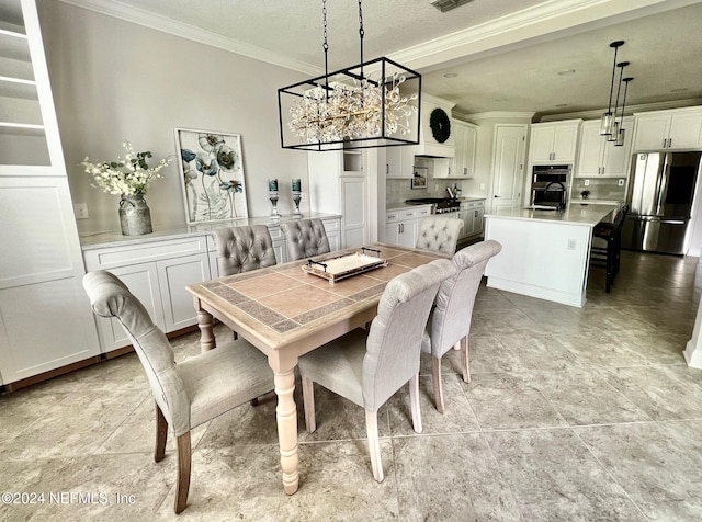 dining area with ornamental molding and a textured ceiling