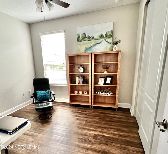 sitting room with a textured ceiling, dark hardwood / wood-style floors, and ceiling fan