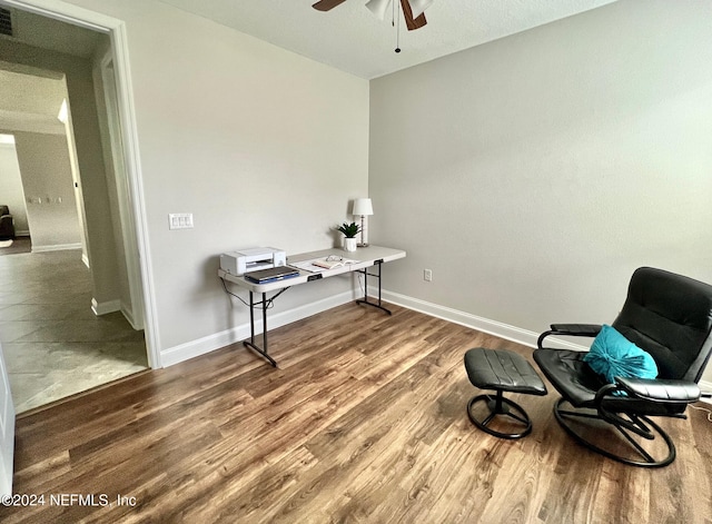 sitting room with ceiling fan and hardwood / wood-style flooring