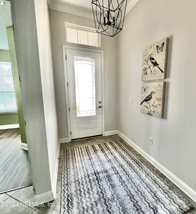 entrance foyer featuring a chandelier, a healthy amount of sunlight, and hardwood / wood-style flooring