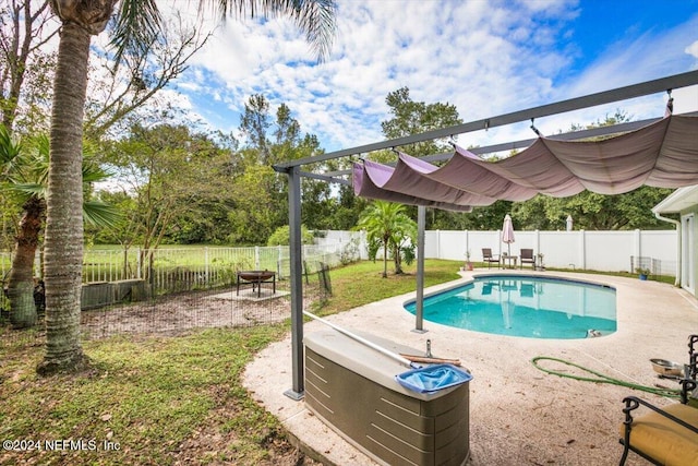 view of swimming pool featuring a lawn and a patio