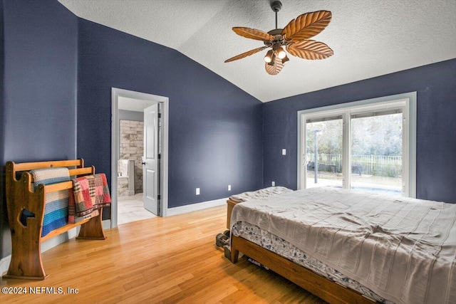 bedroom featuring ensuite bath, access to outside, vaulted ceiling, ceiling fan, and wood-type flooring