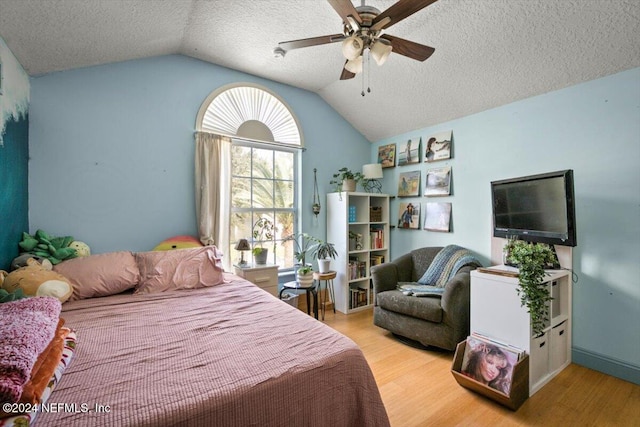 bedroom with a textured ceiling, ceiling fan, lofted ceiling, and light wood-type flooring