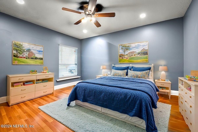 bedroom featuring ceiling fan and light hardwood / wood-style floors