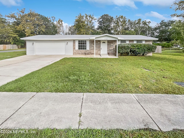 single story home featuring a garage and a front yard