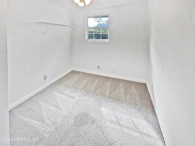 spare room featuring carpet flooring and ceiling fan