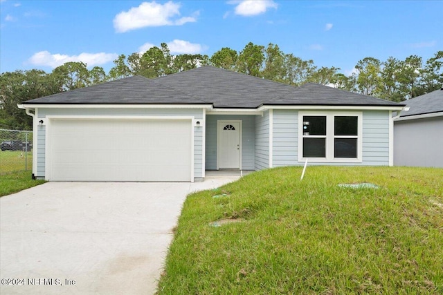 single story home with a garage and a front lawn