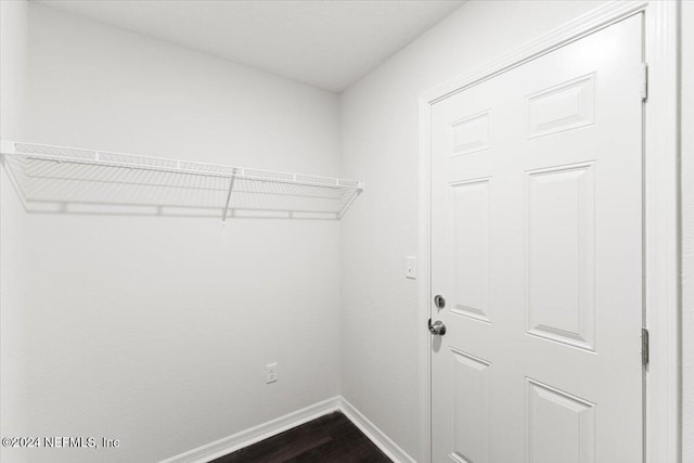 clothes washing area featuring hardwood / wood-style flooring