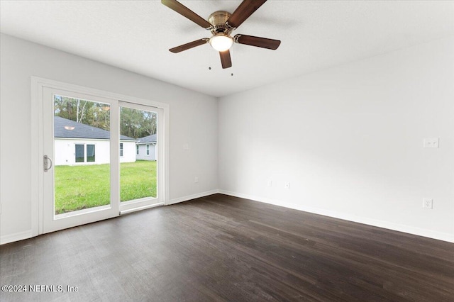 unfurnished room with dark wood-type flooring and ceiling fan