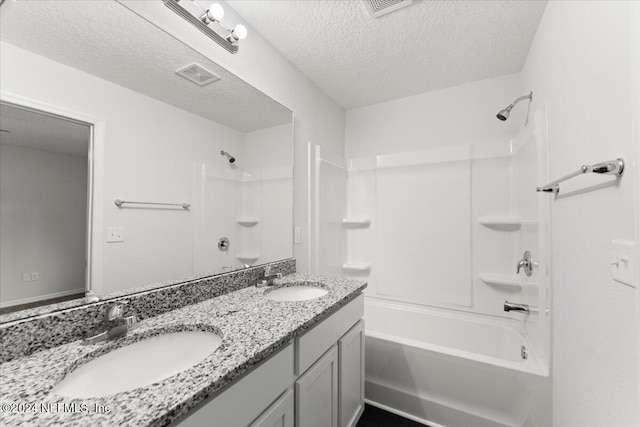 bathroom with vanity, a textured ceiling, and shower / bathtub combination