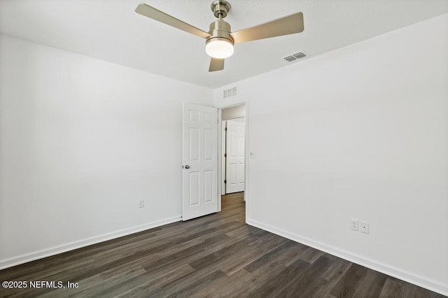 spare room with ceiling fan and dark hardwood / wood-style flooring