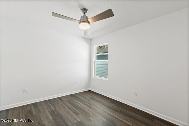 empty room featuring ceiling fan and dark hardwood / wood-style flooring