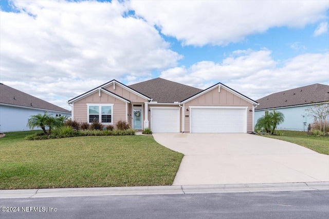 view of front of home featuring a garage and a front lawn