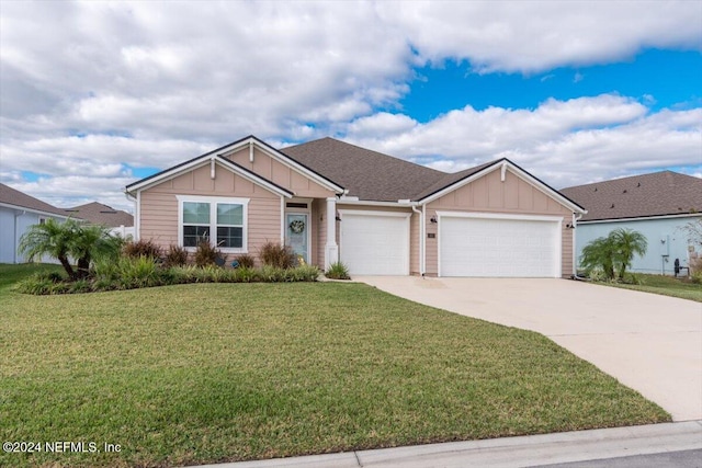 view of front of home with a front lawn and a garage