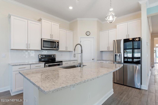 kitchen featuring white cabinets, stainless steel appliances, light hardwood / wood-style flooring, and a kitchen island with sink