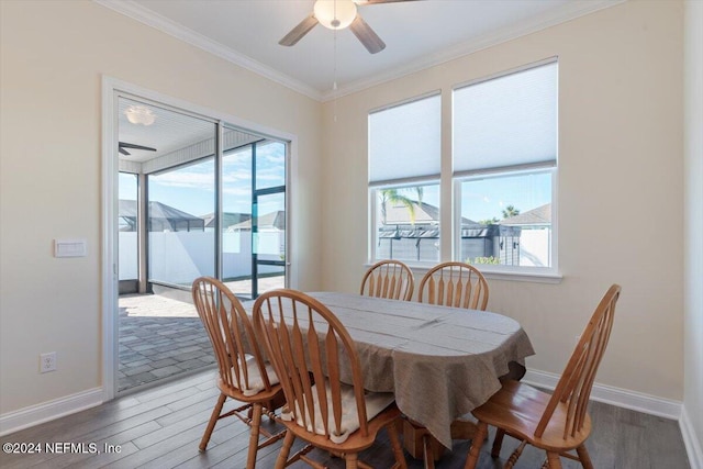 dining room featuring a wealth of natural light, hardwood / wood-style floors, ceiling fan, and ornamental molding