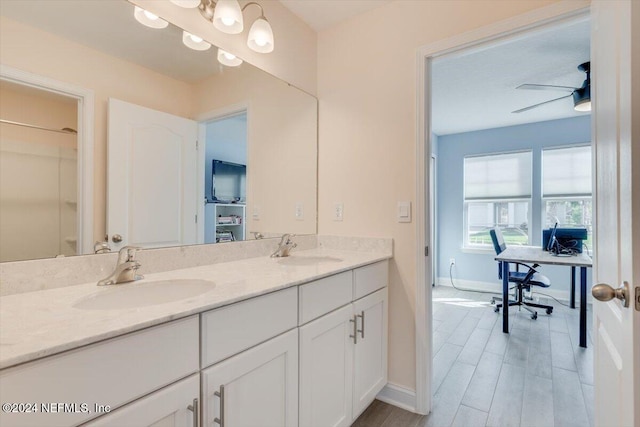 bathroom featuring hardwood / wood-style floors, vanity, and ceiling fan