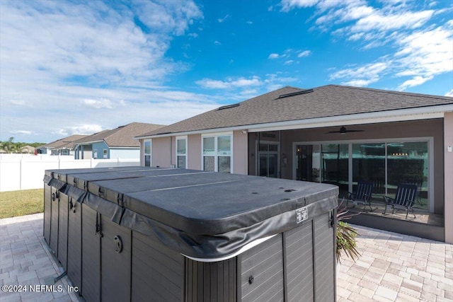 view of patio / terrace featuring ceiling fan and a hot tub