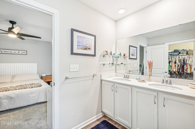 bathroom featuring hardwood / wood-style floors, ceiling fan, and vanity