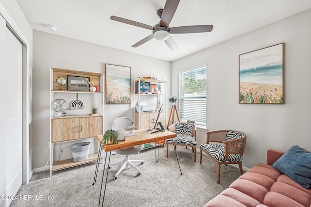 carpeted office space featuring a textured ceiling and ceiling fan