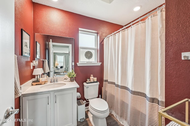 bathroom with hardwood / wood-style flooring, vanity, and toilet