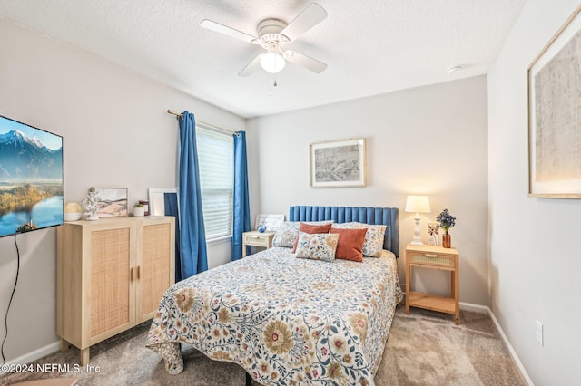 bedroom with a textured ceiling, light carpet, and ceiling fan