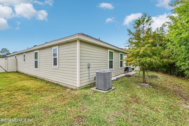 view of home's exterior with a yard and cooling unit