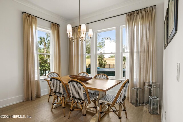 55A Solana Rd, Ponte Vedra Beach, FL 32082 - dining area featuring plenty of natural light, crown molding, a chandelier, and light wood finished floors