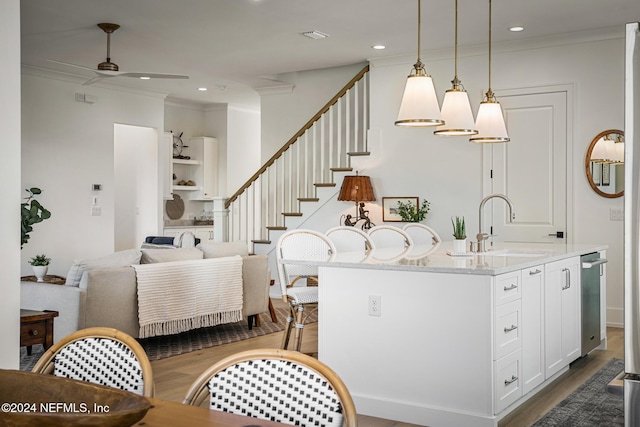 55A Solana Rd, Ponte Vedra Beach, FL 32082 - kitchen with ceiling fan, crown molding, dark wood-style floors, white cabinets, and light stone counters