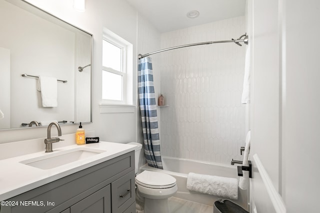 bathroom with toilet, shower / tub combo, and vanity