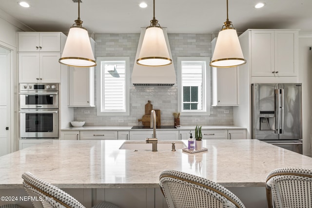 kitchen with stainless steel appliances, a wealth of natural light, a kitchen bar, and tasteful backsplash