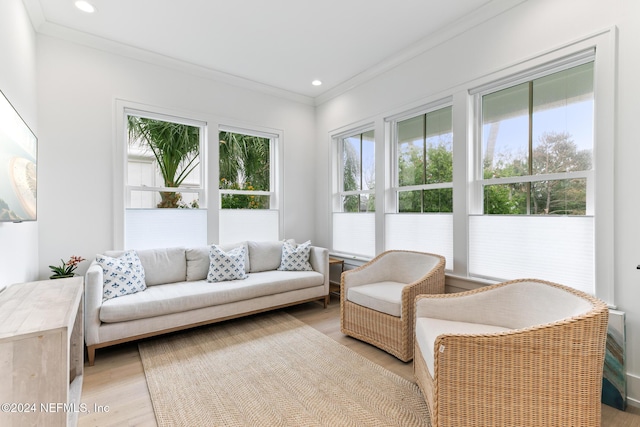 living room featuring light wood-style floors, crown molding, and recessed lighting