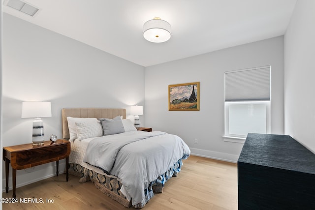 bedroom featuring baseboards, visible vents, and light wood-style floors