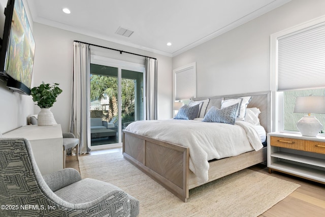 bedroom with access to exterior, visible vents, crown molding, and wood finished floors