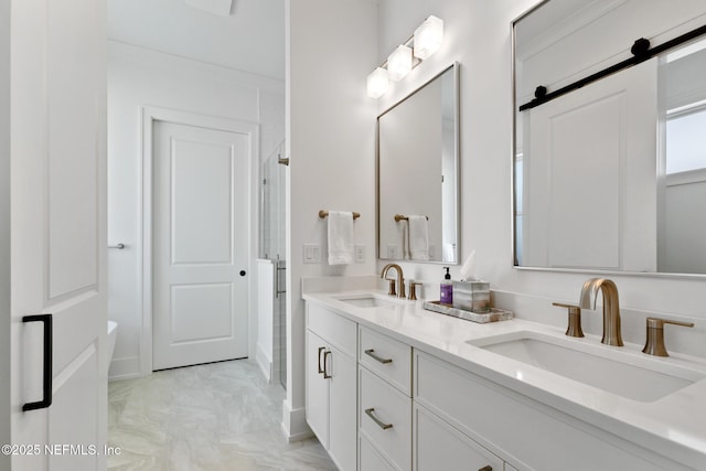 bathroom featuring double vanity, an enclosed shower, and a sink