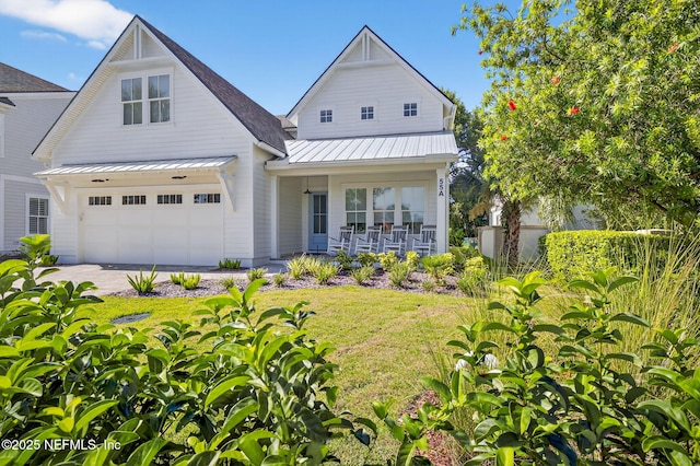 55A Solana Rd, Ponte Vedra Beach, FL 32082 - view of front facade with covered porch, a standing seam roof, a metal roof, and a garage