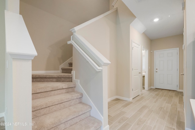 stairway with hardwood / wood-style flooring